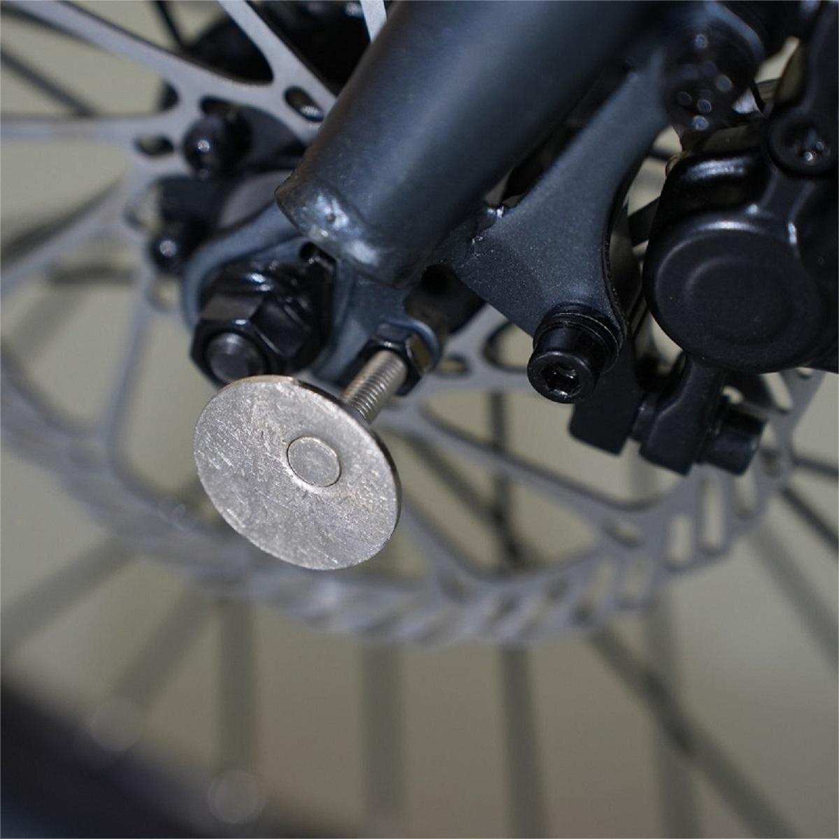 a close up of an ADO bicycle wheel with a metal disc