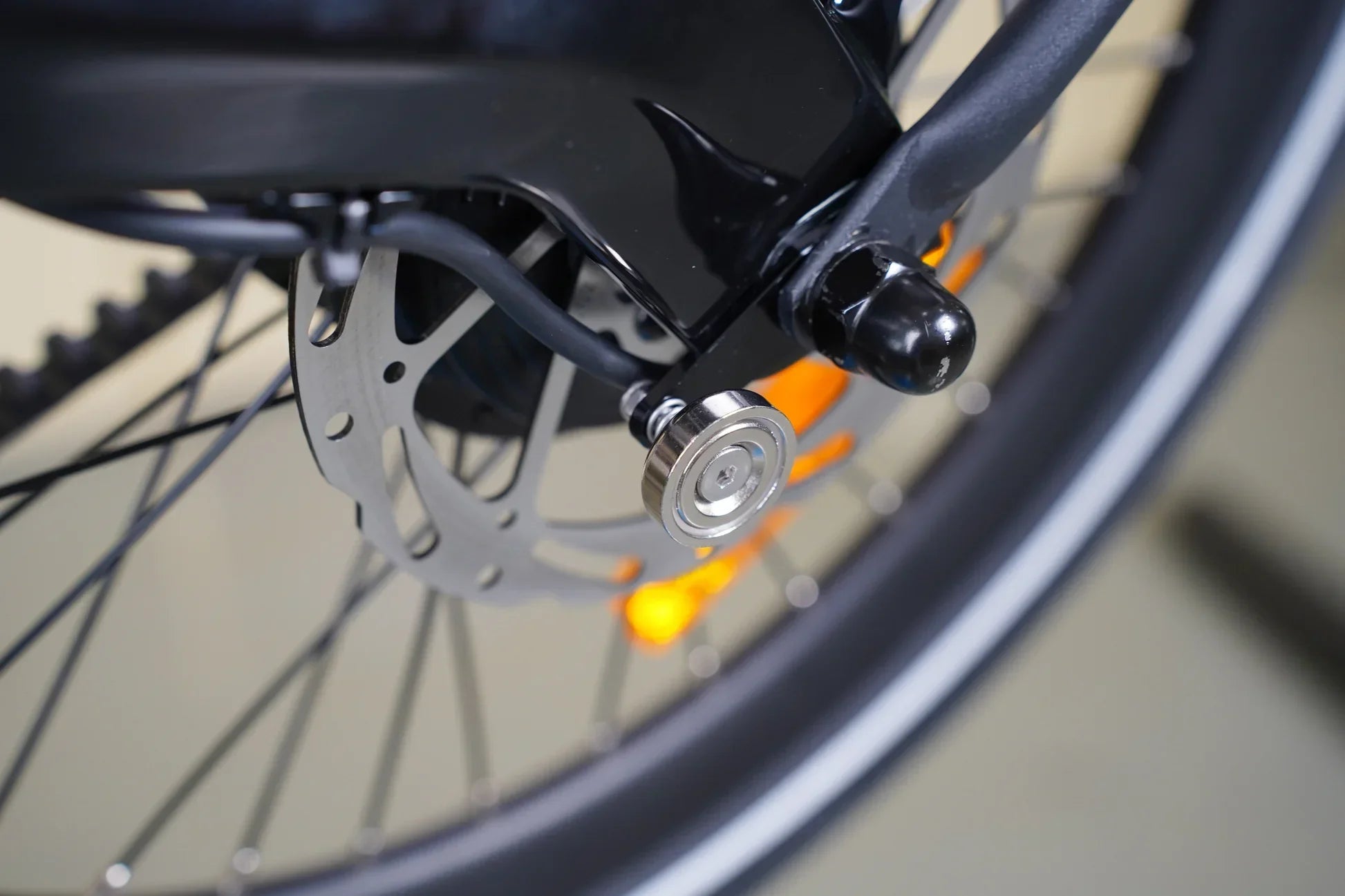 Close-up of bicycle wheel hub with magnetic buckle and disc brake rotor