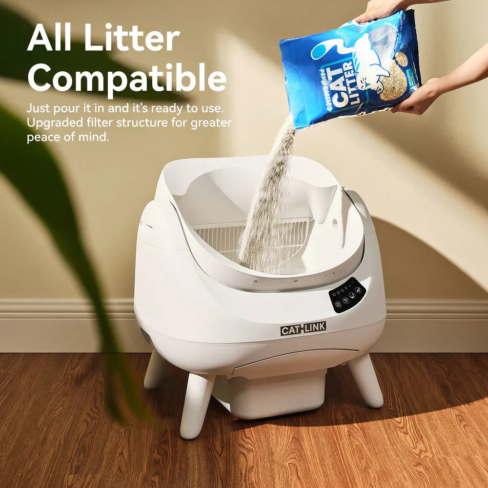 Pouring cat litter into white CATLINK automatic litter box on wooden floor