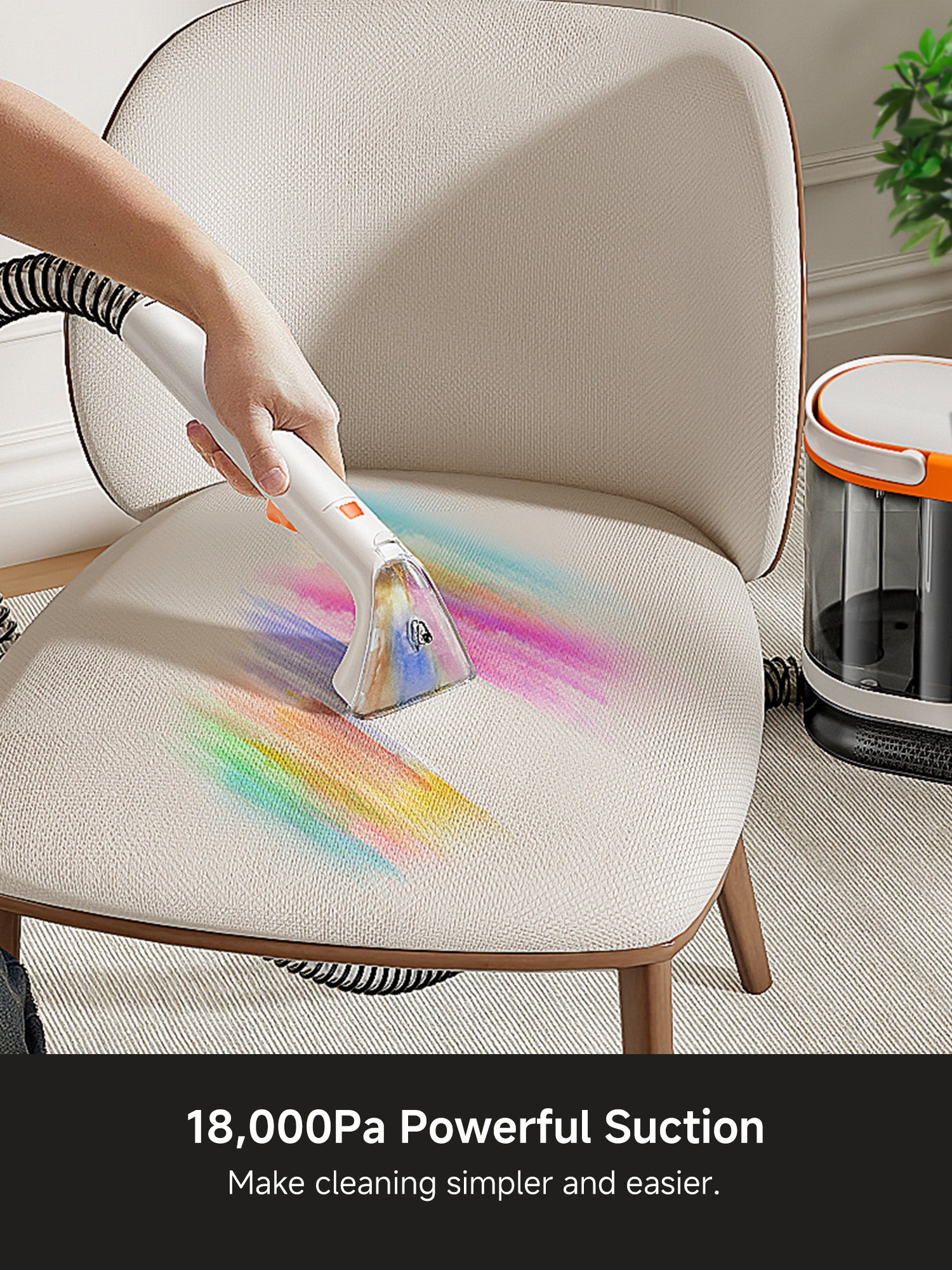 Hand using upholstery cleaner with powerful suction to remove colorful stains from beige fabric chair