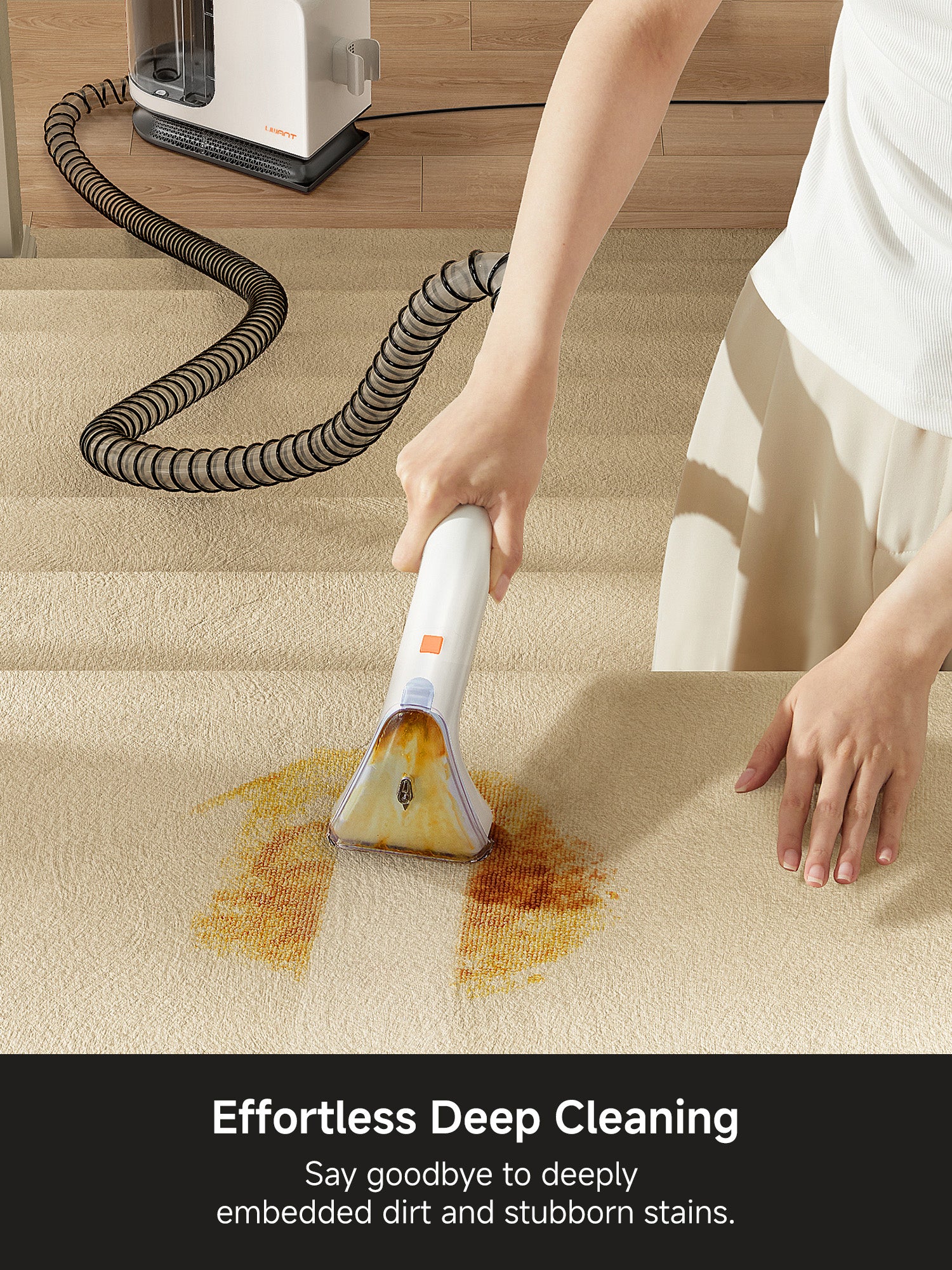 Person using a white carpet cleaner to remove brown stains from beige carpet with deep cleaning machine