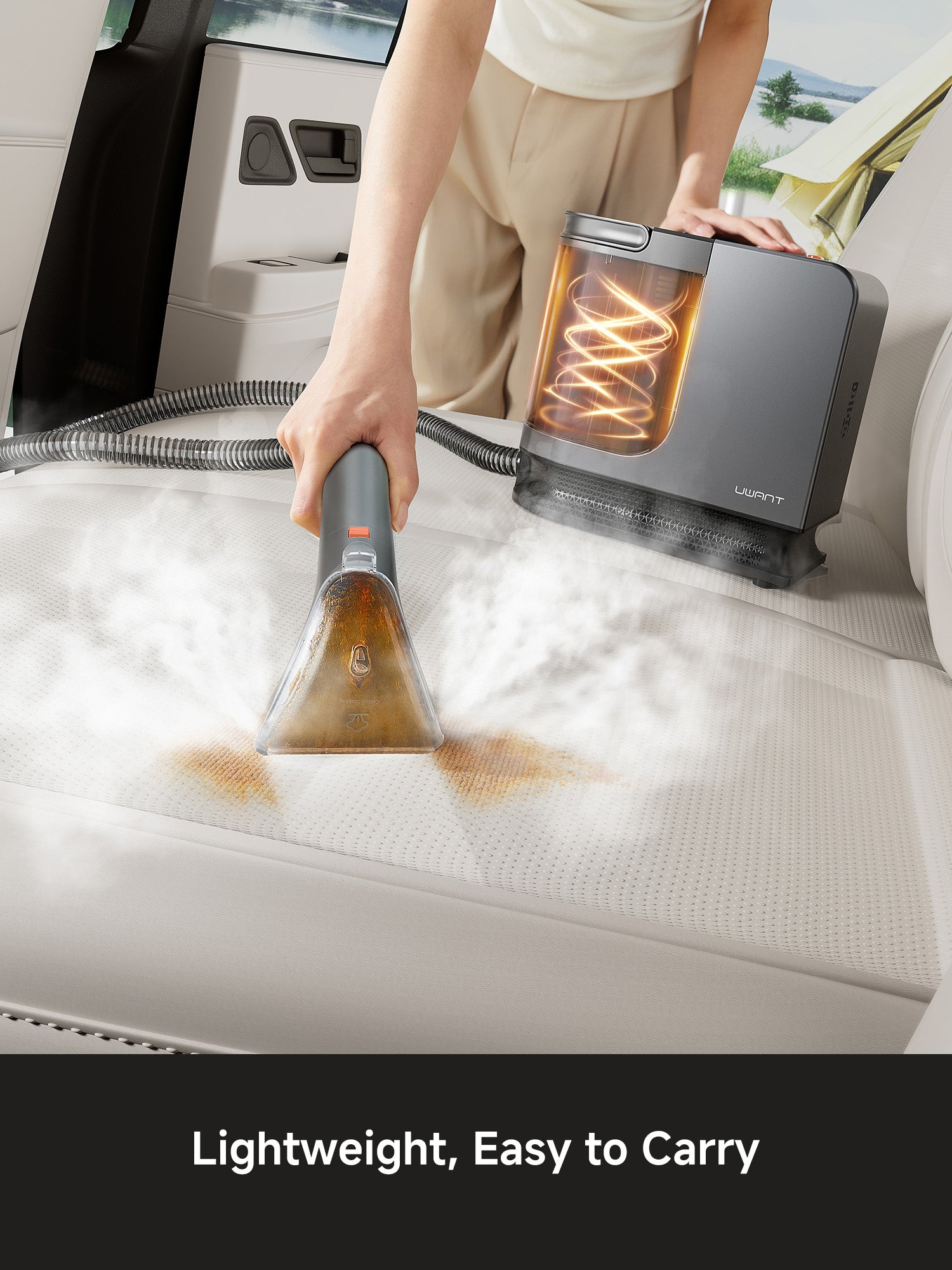 Portable steam cleaner removing brown stain from light car seat upholstery