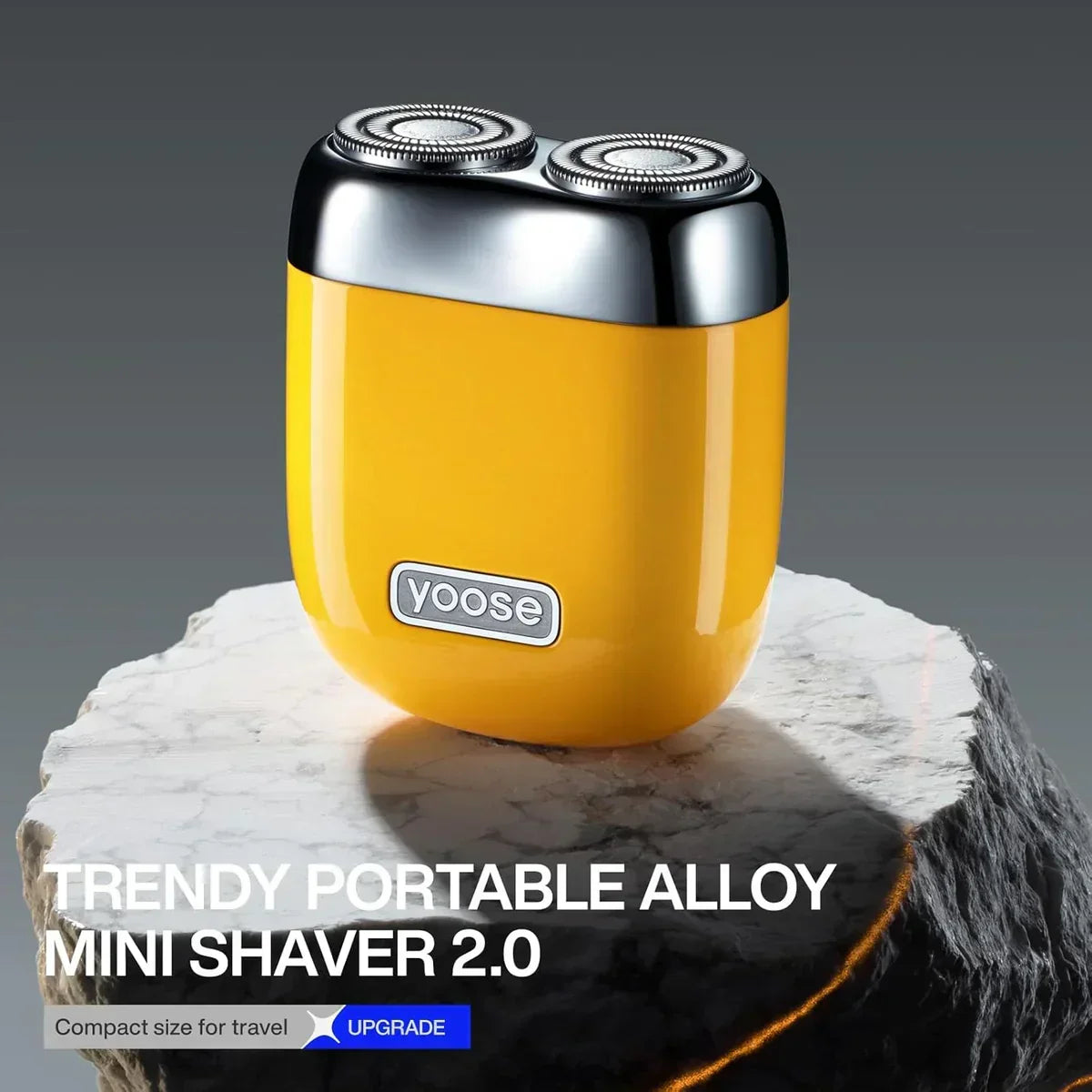 Yellow Yoose portable alloy mini shaver 2.0 with dual silver rotary heads on marble surface