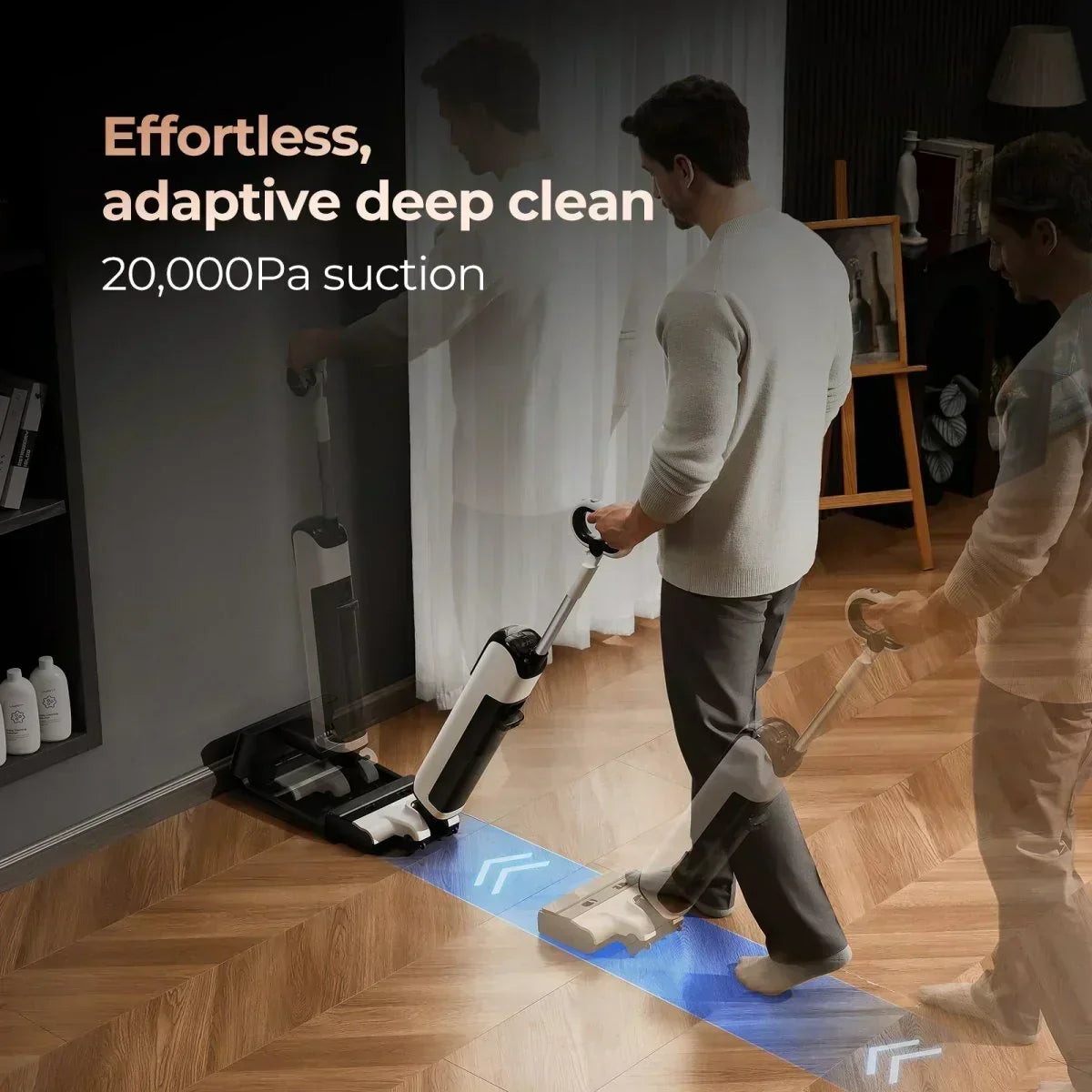 Man using cordless vacuum cleaner on wooden floor near docking station with 20,000Pa suction