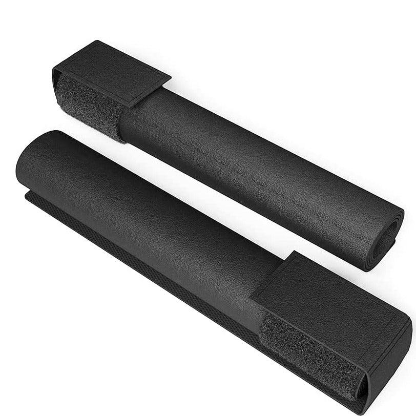 Two black foam assistive covers with Velcro straps on a white background