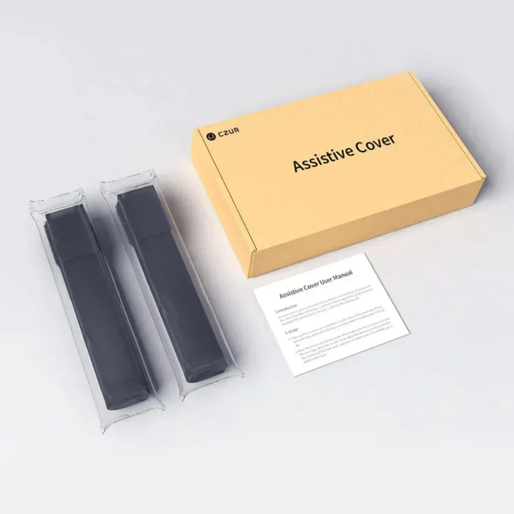 CZUR Assistive Cover kit with two black covers in plastic sleeves and user manual on white background