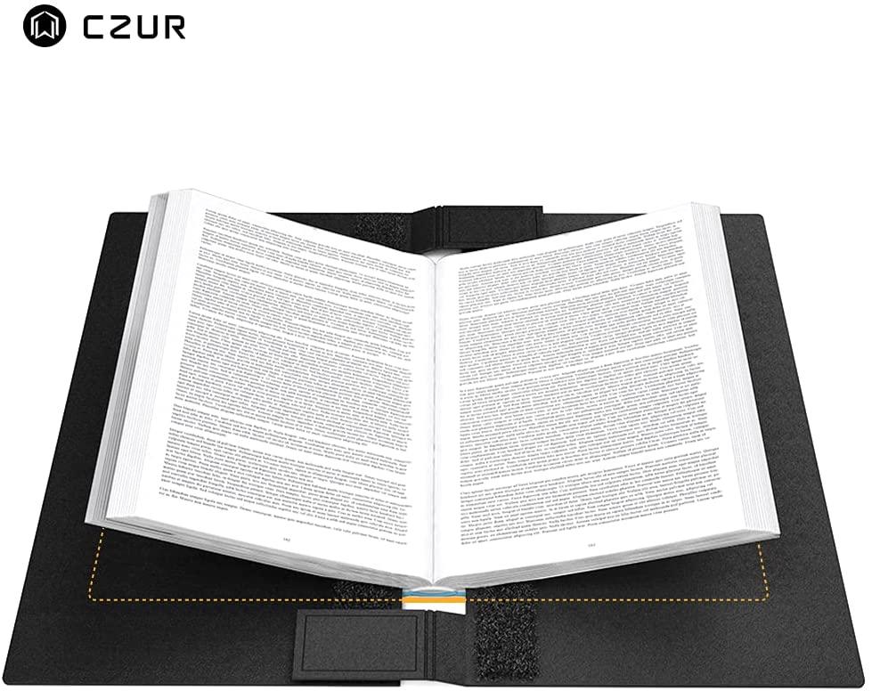 Open book held by black CZUR assistive cover with Velcro straps on white background