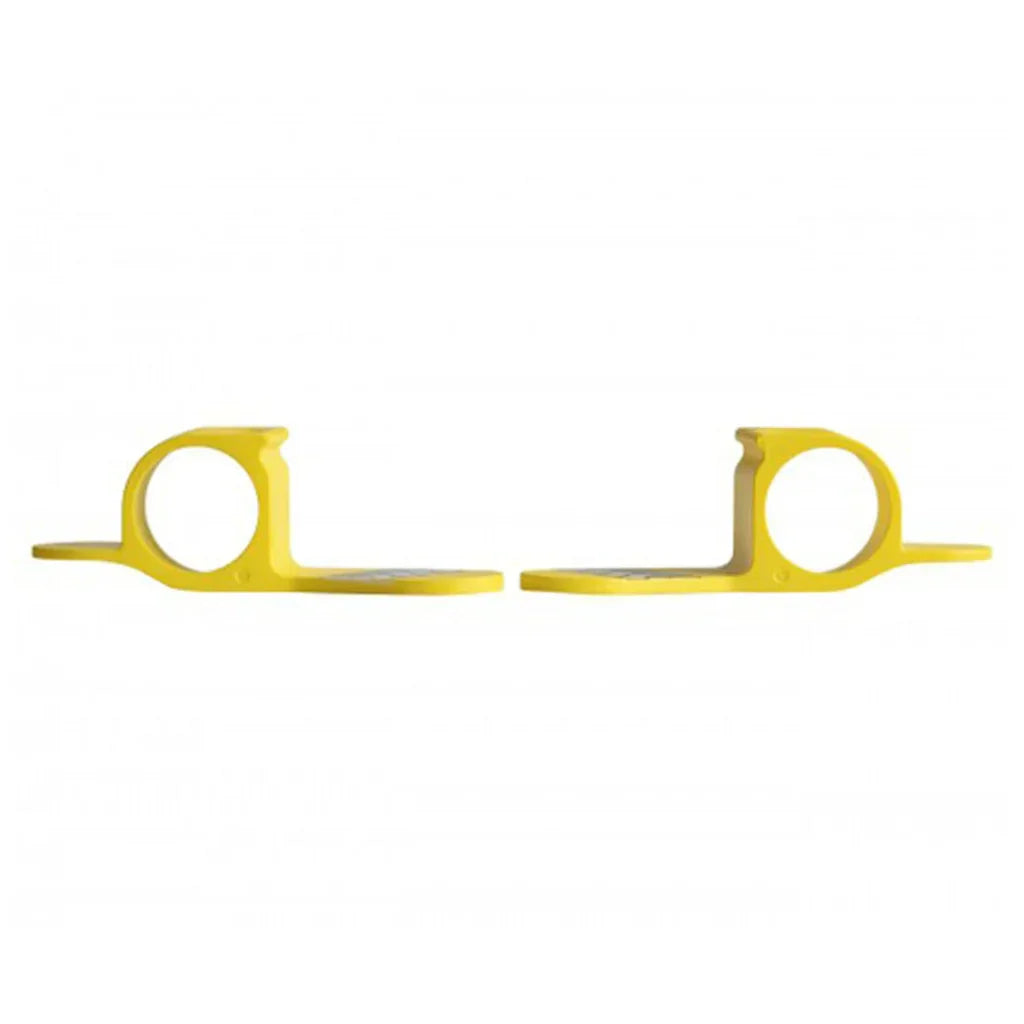 Pair of yellow plastic finger cot tools with rounded openings on a white background