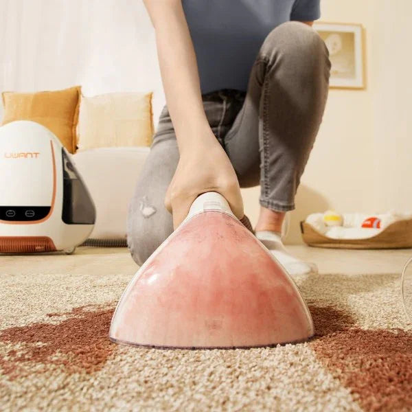 Person using a Uwant B100 carpet spot cleaner on beige and brown carpet stain in living room