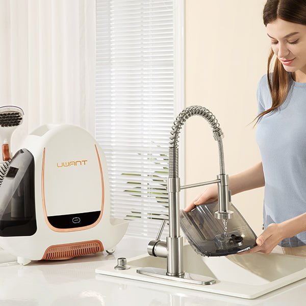 Woman rinsing a transparent vacuum cleaner water tank under a modern kitchen sink faucet next to a white UWANT vacuum cleaner
