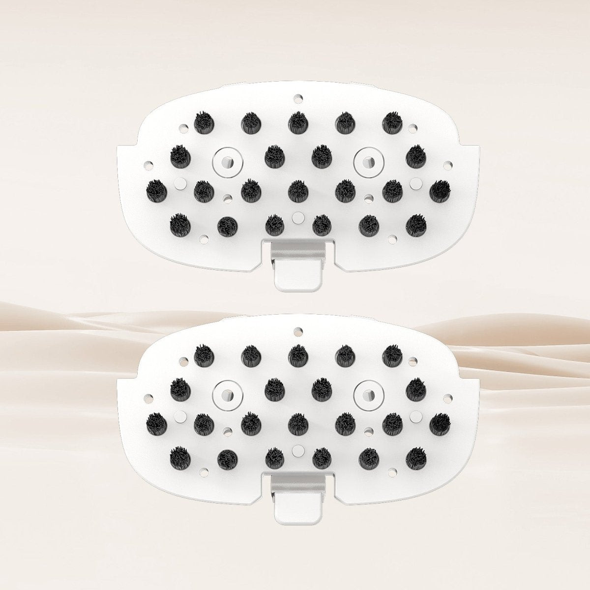 Two white replaceable brush attachments with black bristles for cleaning different surfaces