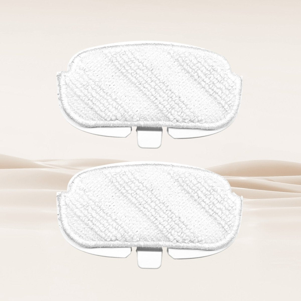 Two white replaceable microfiber mop pads for cleaning different surfaces, with textured fabric